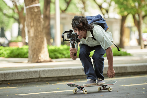 Video Grapher on a skateboard